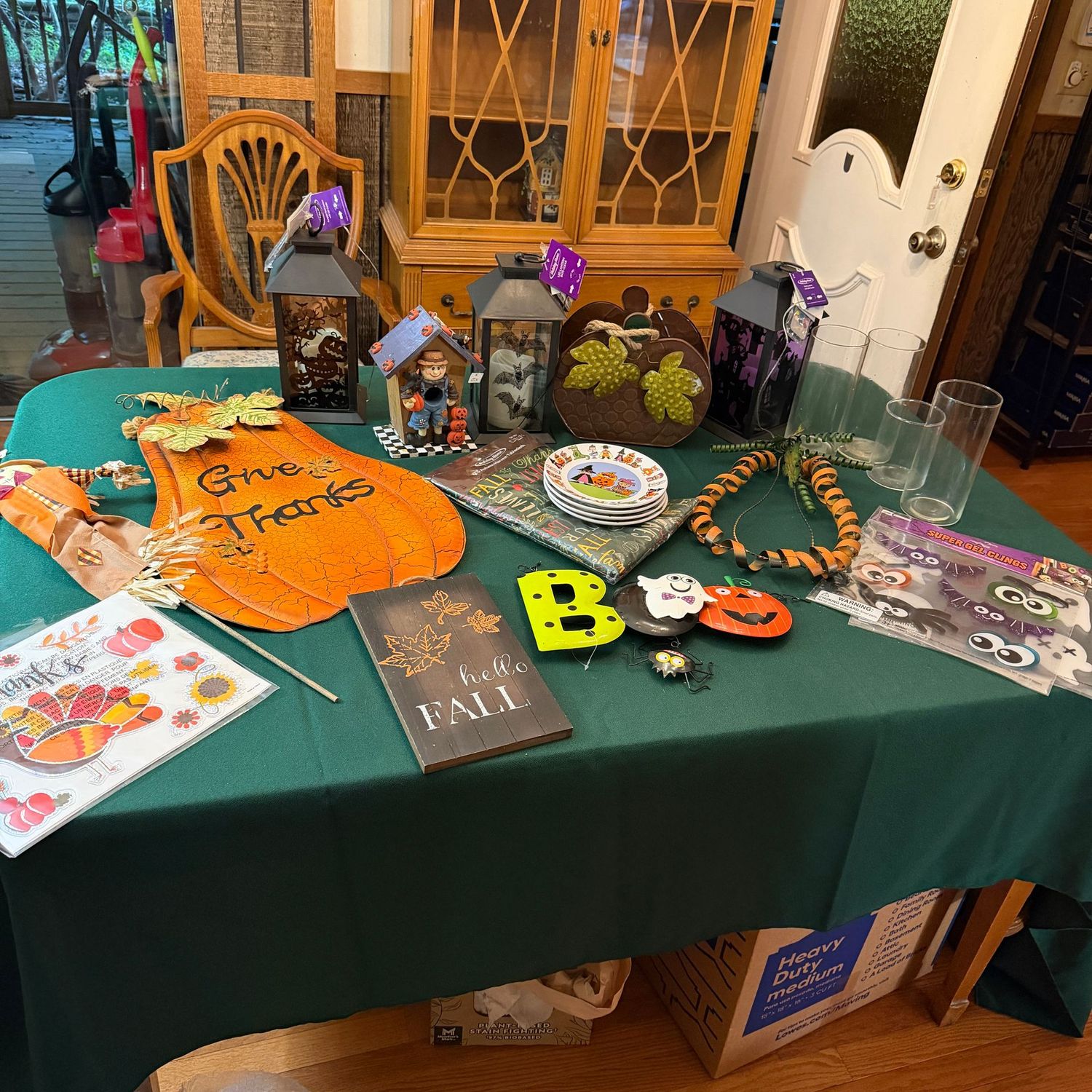 Bin of Halloween and fall decorations, 25 Bin of Halloween and fall decorations, 25"H metal pumpkin, decals, candle holders, plates, lanterns, and more, B0521