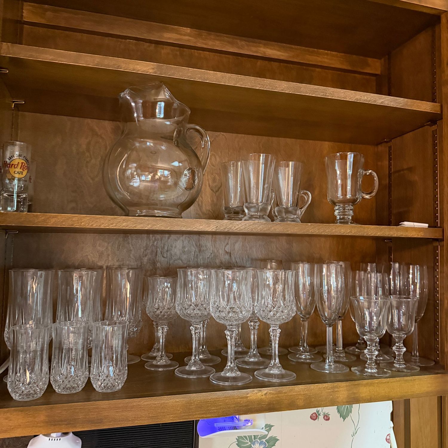 Cupboard A - Two shelves with a variety of glassware and glass pitcher Cupboard A - Two shelves with a variety of glassware and glass pitcher