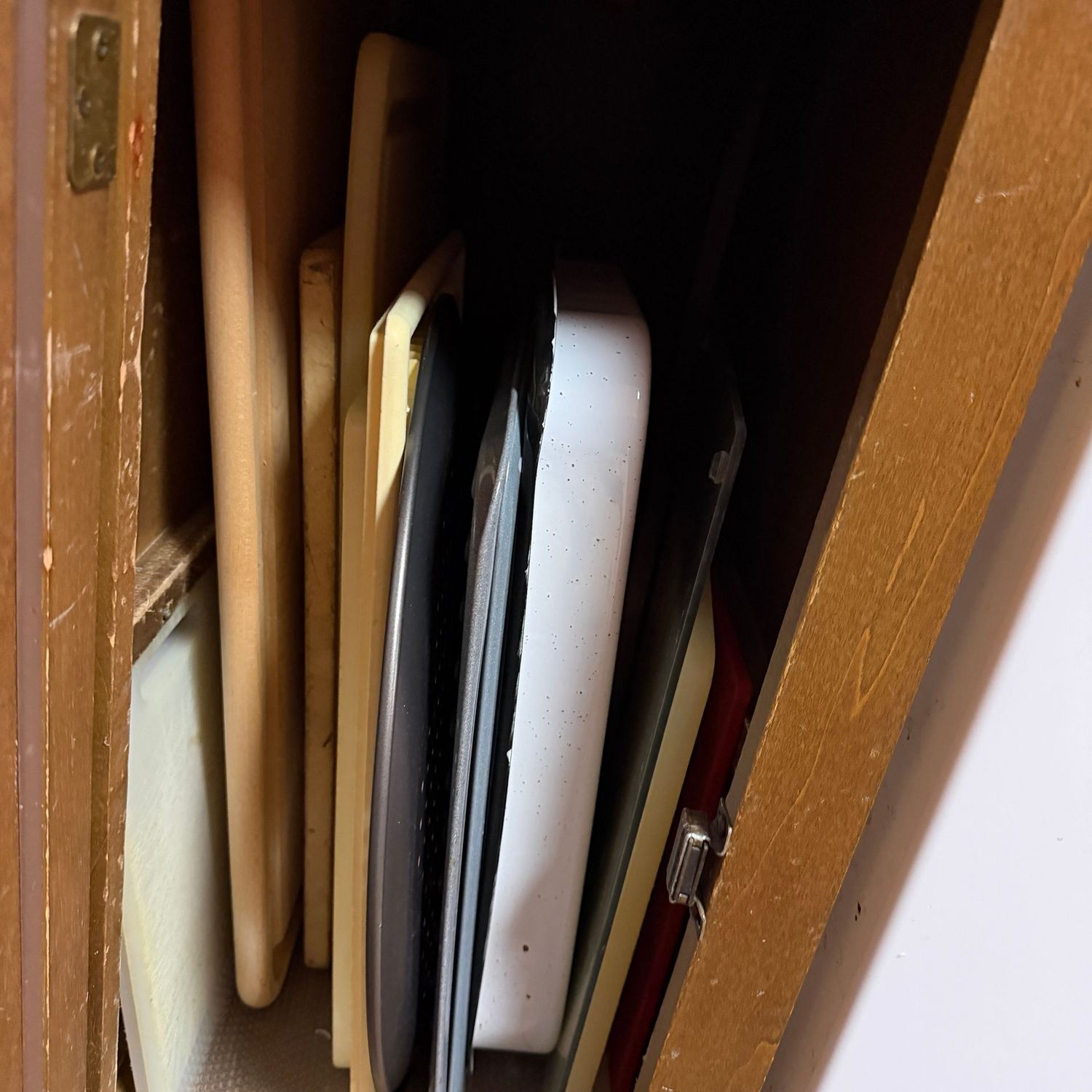Cupboard C - filled with large cutting boards, pizza pan, enameled pans Cupboard C - filled with large cutting boards, pizza pan, enameled pans