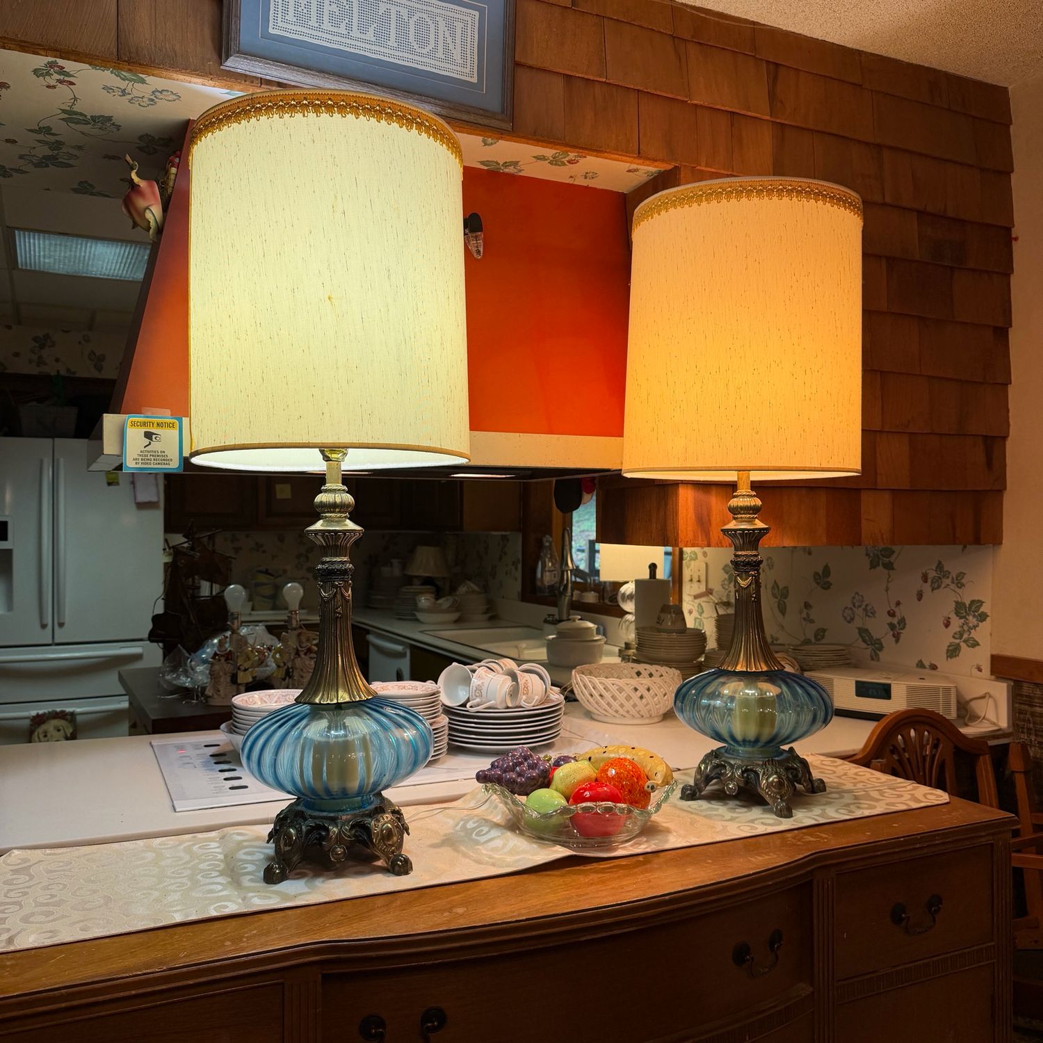 Pair of tall mid-century blue glass table lamps, cast brass neck and feet, shades show some mild spotting, 3.5 feet tall Pair of tall mid-century blue glass table lamps, cast brass neck and feet, shades show some mild spotting, 3.5 feet tall
