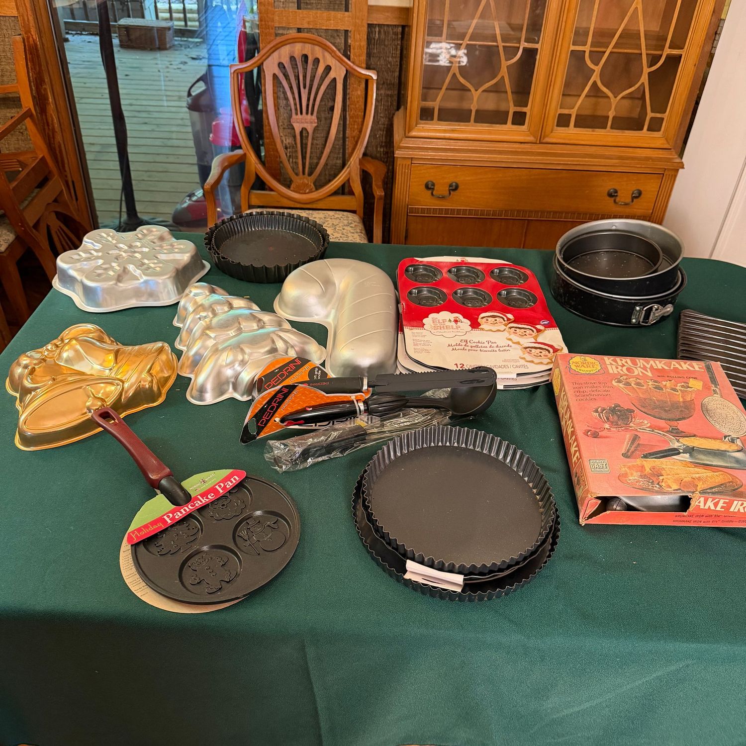 Kitchen box lot B0670 tart pans, springform, cupcake pan, utensils, Christmas cake pans, Elf on the Shelf Wilton cookie pans, krumkake iron Kitchen box lot B0670 tart pans, springform, cupcake pan, utensils, Christmas cake pans, Elf on the Shelf Wilton cookie pans, krumkake iron