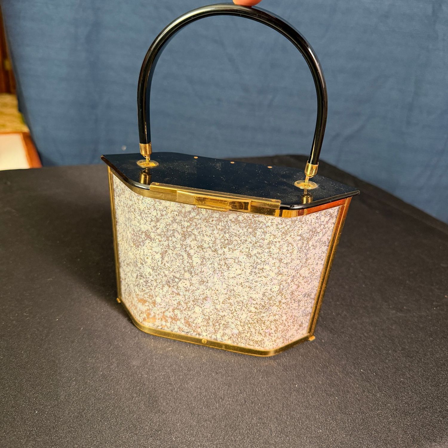 Mid-century lucite purse with black lid and handle, metal frame with brass finish, 5"H x 7"W