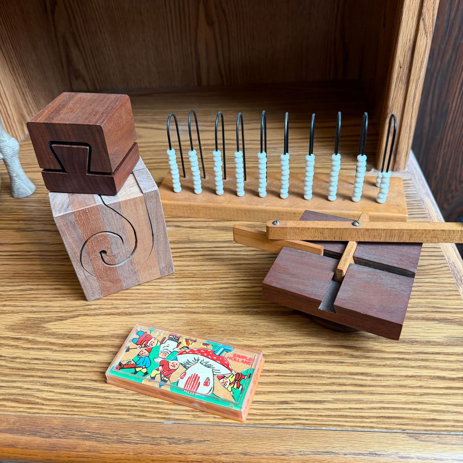 Group of mostly wooden puzzle games