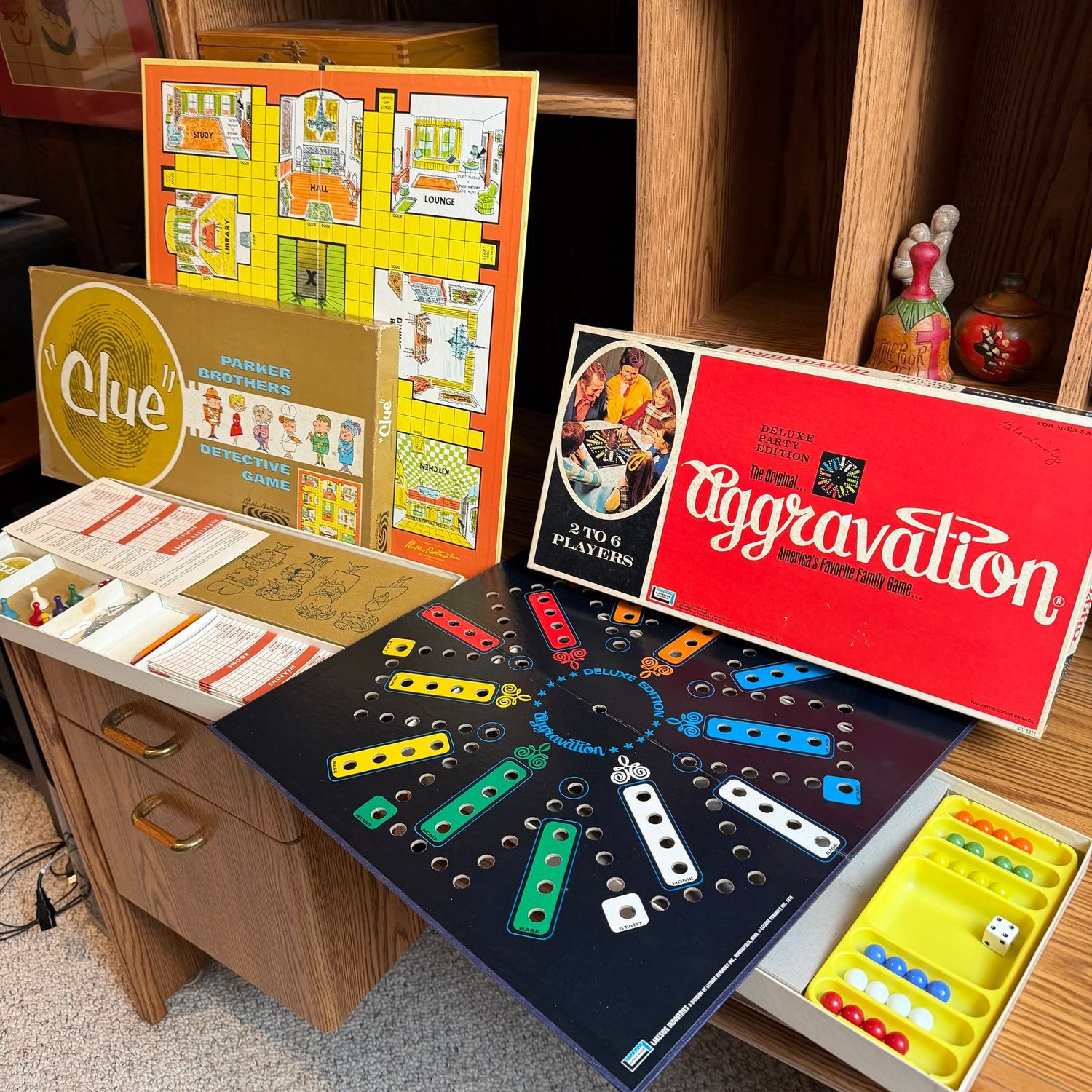 Vintage Clue and Aggravation board games with pieces seen