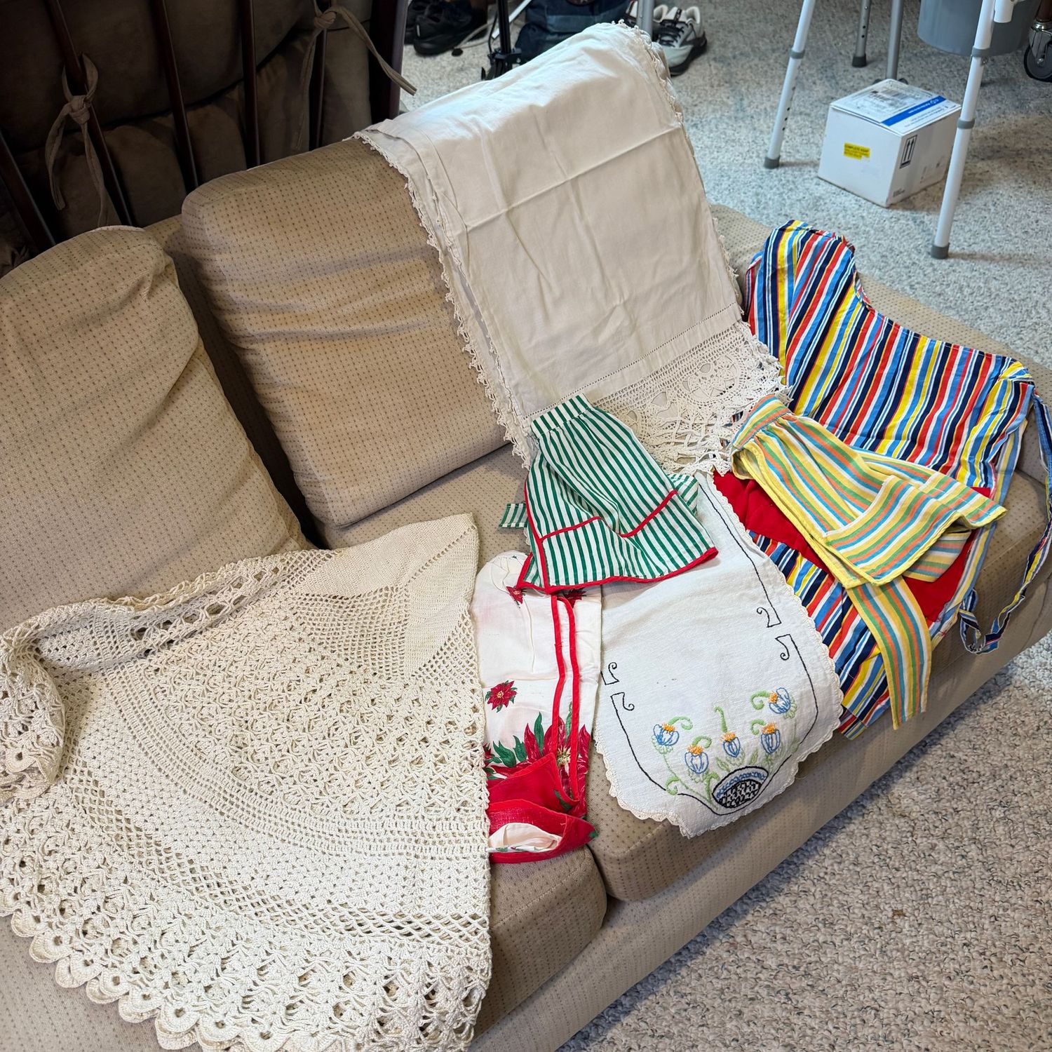 Group of vintage aprons (small), linens, round crocheted table cover