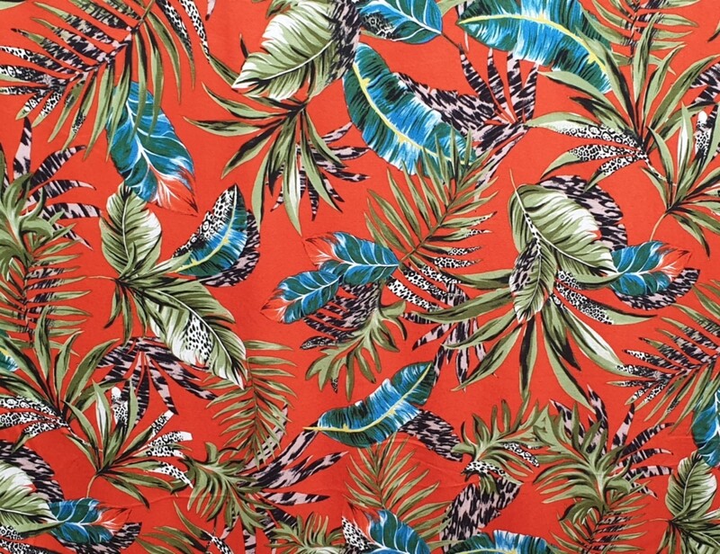 Orange Viscose stretch  leafy botanics print dress fabric.