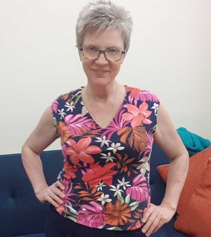 Woman wearing handmade  bright floral top to promote stretch top  sewing workshop