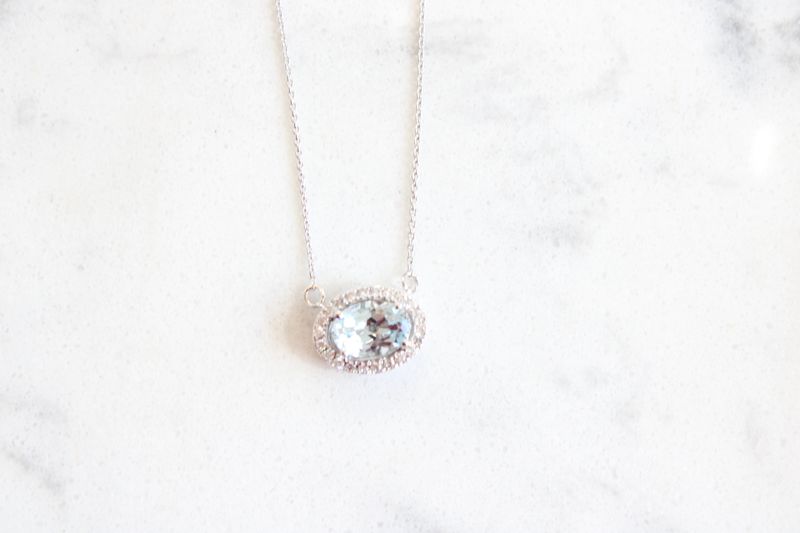 14kt White Gold .09ct Diamond .72ct Oval Aquamarine Halo East to West Necklace