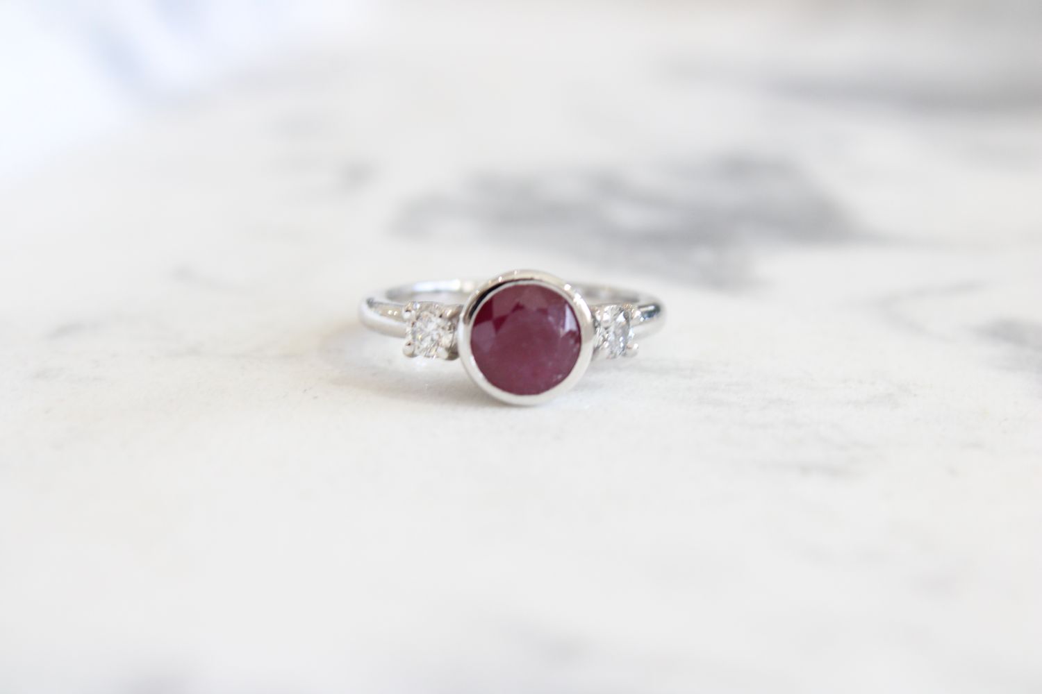 10kt White Gold 7mm Bezel Set Ruby with Diamond Side 3 Stone Ring