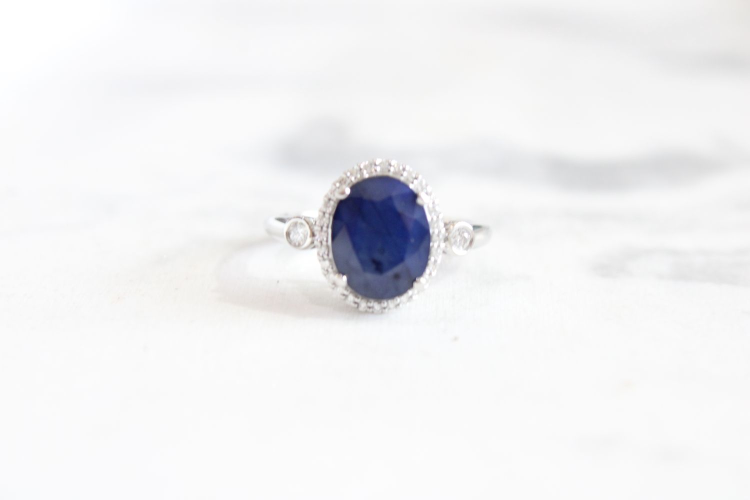 14kt White Gold 10x12mm Oval Sapphire and Diamond Halo with Bezel Accent Ring