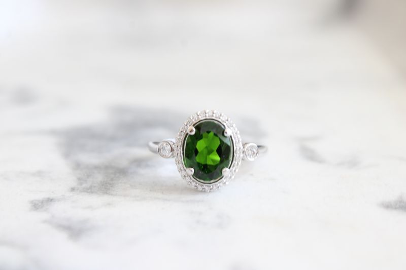 14kt White Gold 9x7mm Oval Tsavorite Garnet and Diamond Halo with Bezel Accent Ring 14kt White Gold 9x7mm Oval Tsavorite Garnet and Diamond Halo with Bezel Accent Ring