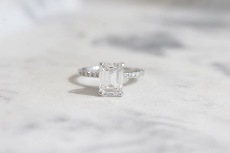 14kw 2.52ct Emerald Cut Lab Grown Diamond Center with Diamond Shank Ring, 12 at .19ct Total 14kw 2.52ct Emerald Cut Lab Grown Diamond Center with Diamond Shank Ring, 12 at .19ct Total