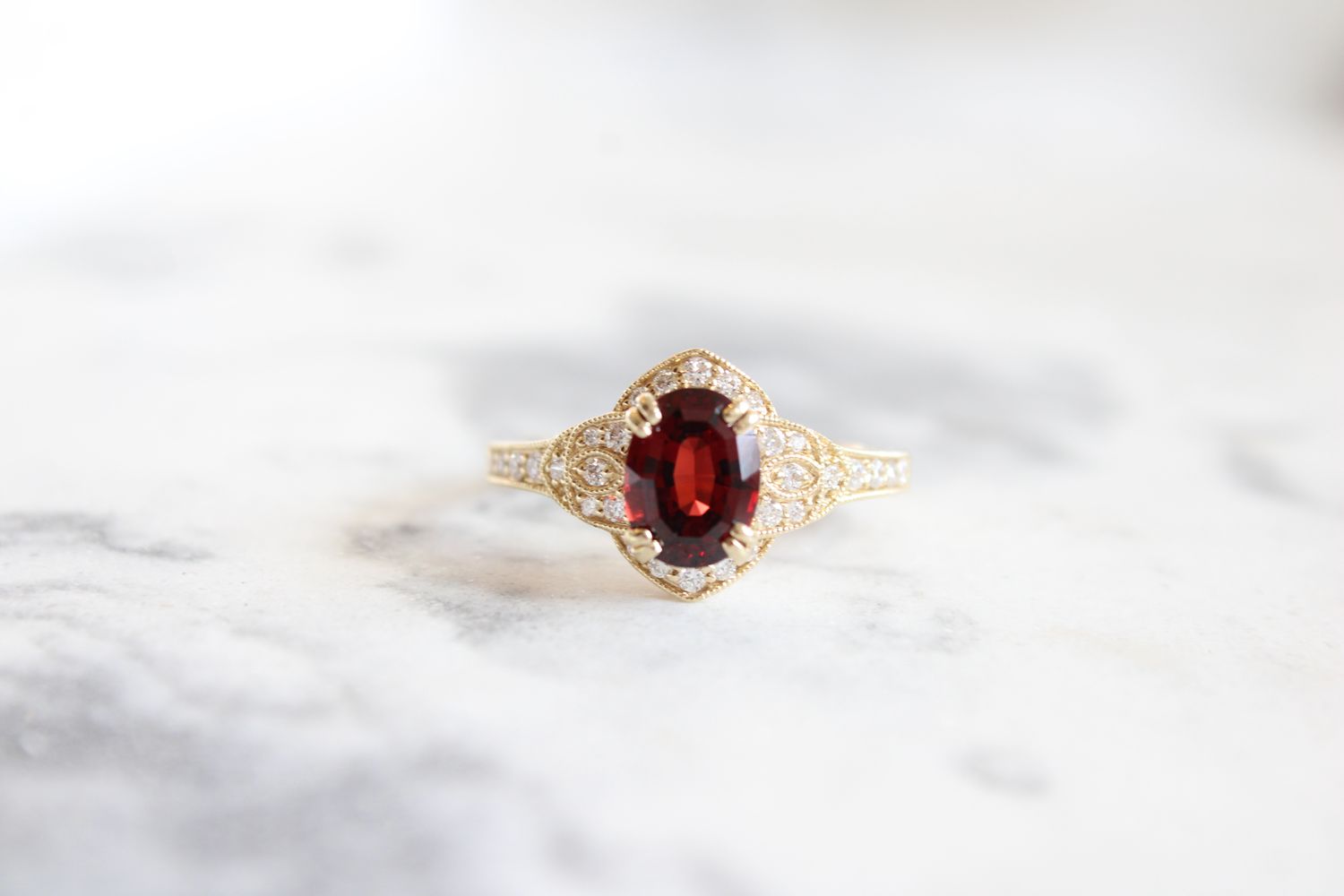 14kt Yellow Gold Oval Garnet with Vintage Inspired Halo, 30 Round Diamonds at .23ct Total 14kt Yellow Gold Oval Garnet with Vintage Inspired Halo, 30 Round Diamonds at .23ct Total