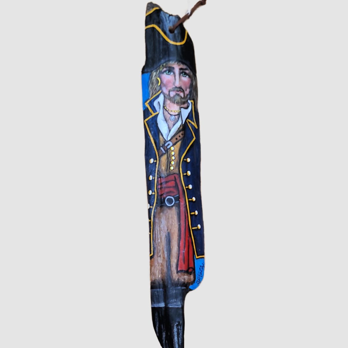 A well dressed Pirate painted on driftwood by D. J. Kelly