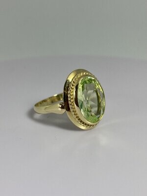 Golden ring with green olivine