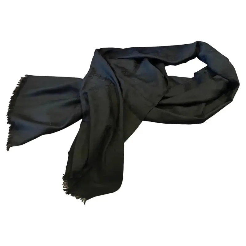 A Never Used Black Wool Scarf by Gucci with Continuous Logo