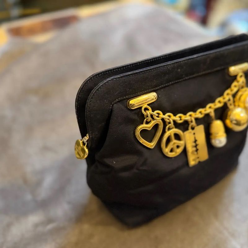 1980s Iconic Black Fabric and Brass Charms Clutch by Franco Moschino