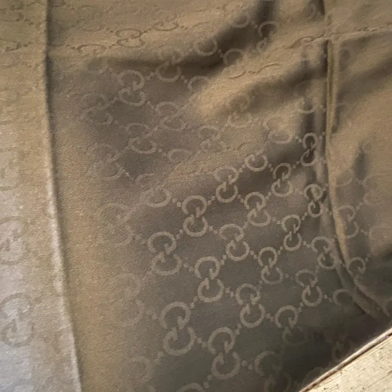 A Never Used Black Wool Scarf by Gucci with Continuous Logo