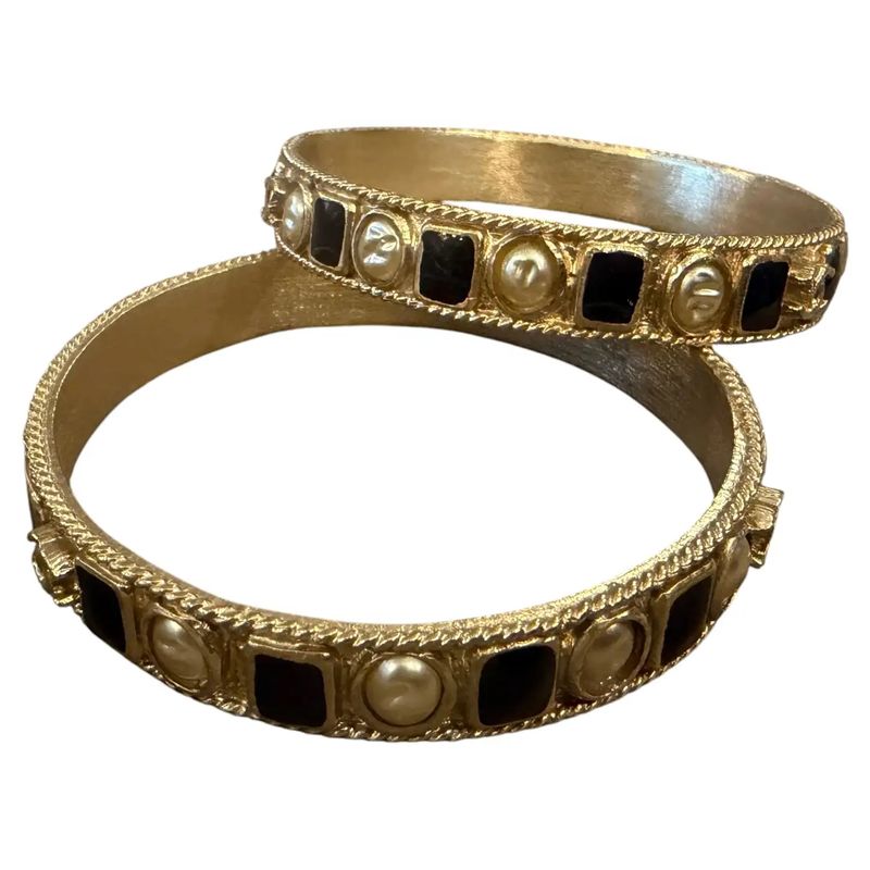 Two 1990s Iconic Gold Plated Metal and Black Enamel Bangle Bracelets by Chanel