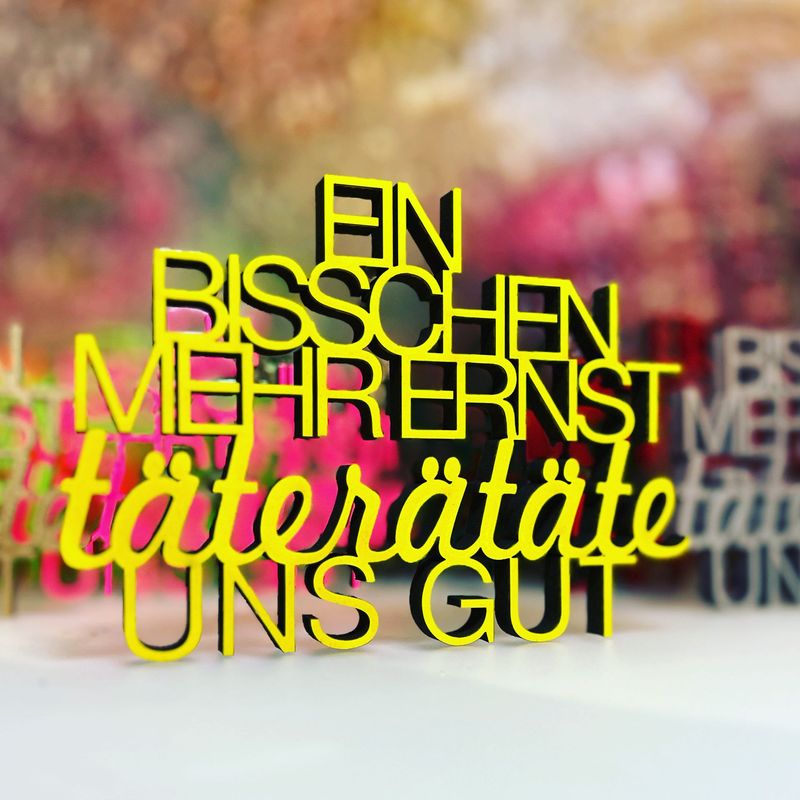 Schriftzug Schriftzug "Ein bisschen mehr ernst täterätäte uns gut"