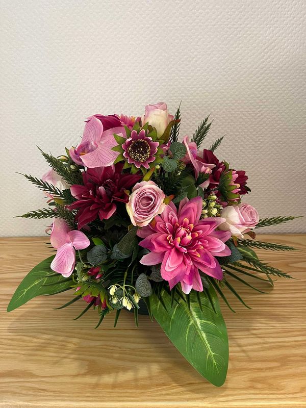 Coussin de fleurs artificielles dqns les tons roses avec fleurons d&#39;orchidées