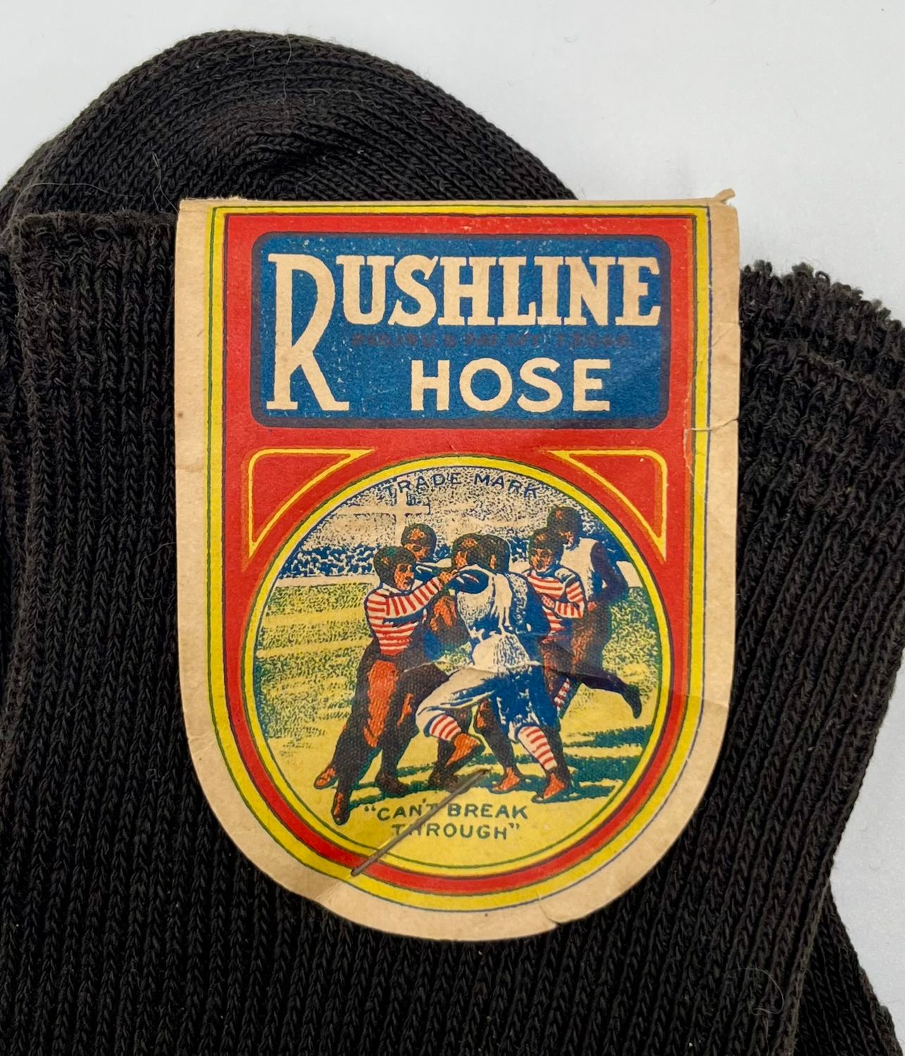 Outstanding Turn-of-the-Century Football Advertising – Unused Vintage Football Hose with Exceptional Multi Color Lithograph Label