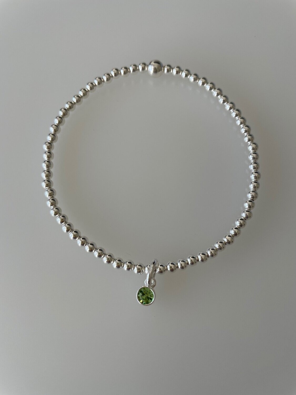 Sterling Silver Stretchy Bracelet With A Peridot Crystal Charm Drop