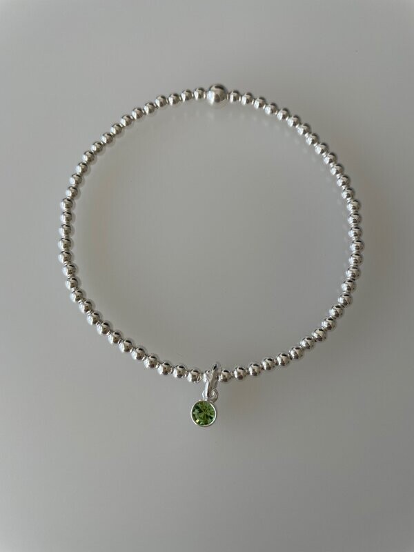 Sterling Silver Stretchy Bracelet With A Peridot Crystal Charm Drop