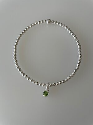 Sterling Silver Stretchy Bracelet With A Peridot Crystal Charm Drop