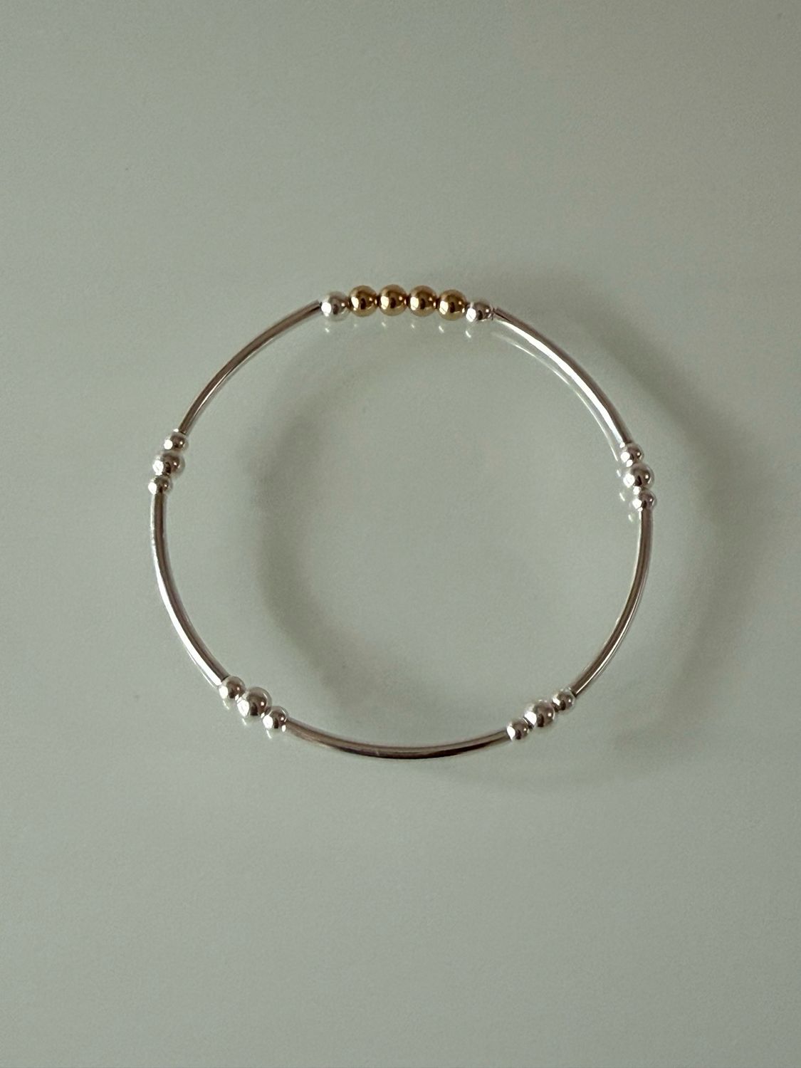 Sterling Silver Tube Bracelet with Gold-Filled Center Bead Sterling Silver Tube Bracelet with Gold-Filled Center Bead