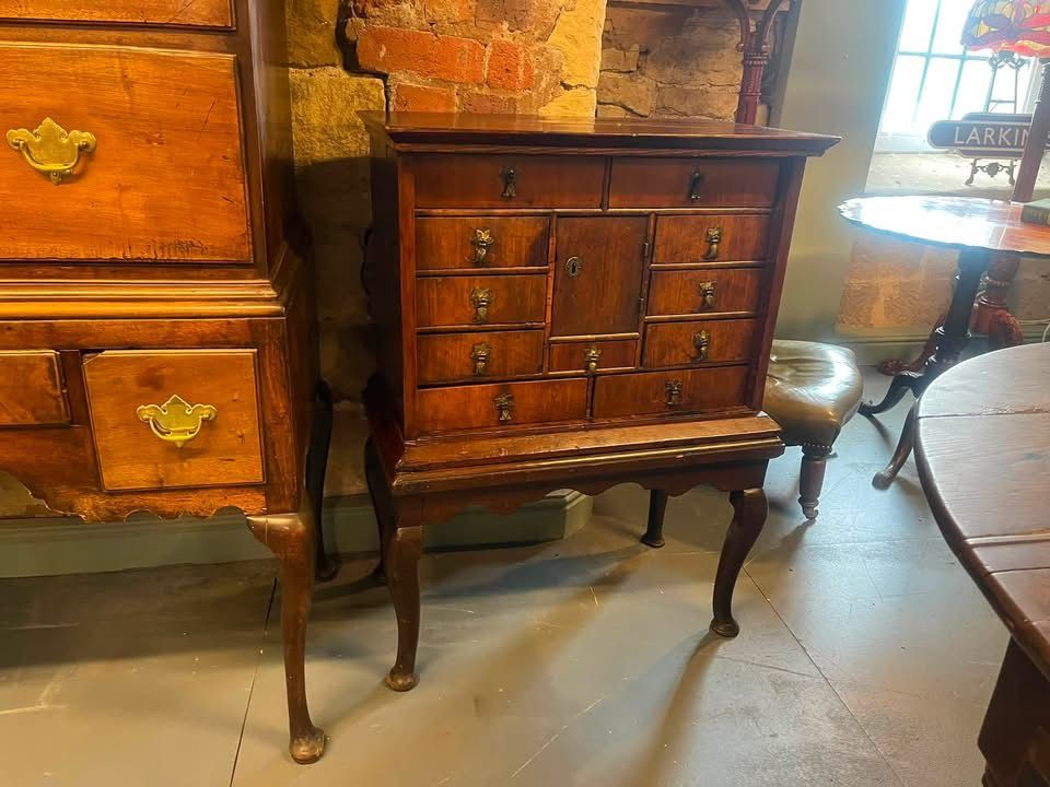 Front view of the Queen Anne walnut cabinet with brass fittings