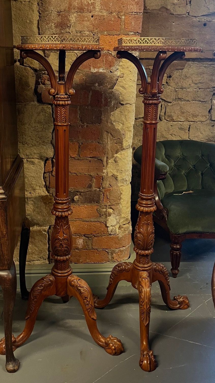 Pair of Carved Wooden Torchère Display Stands Close view of two carved torchère stands showing their shaped supports, decorated columns and tripod bases