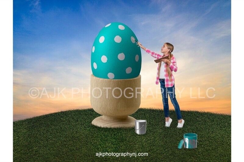 Painting a giant teal Easter egg on a grass hill, blue sky, Easter digital backdrop