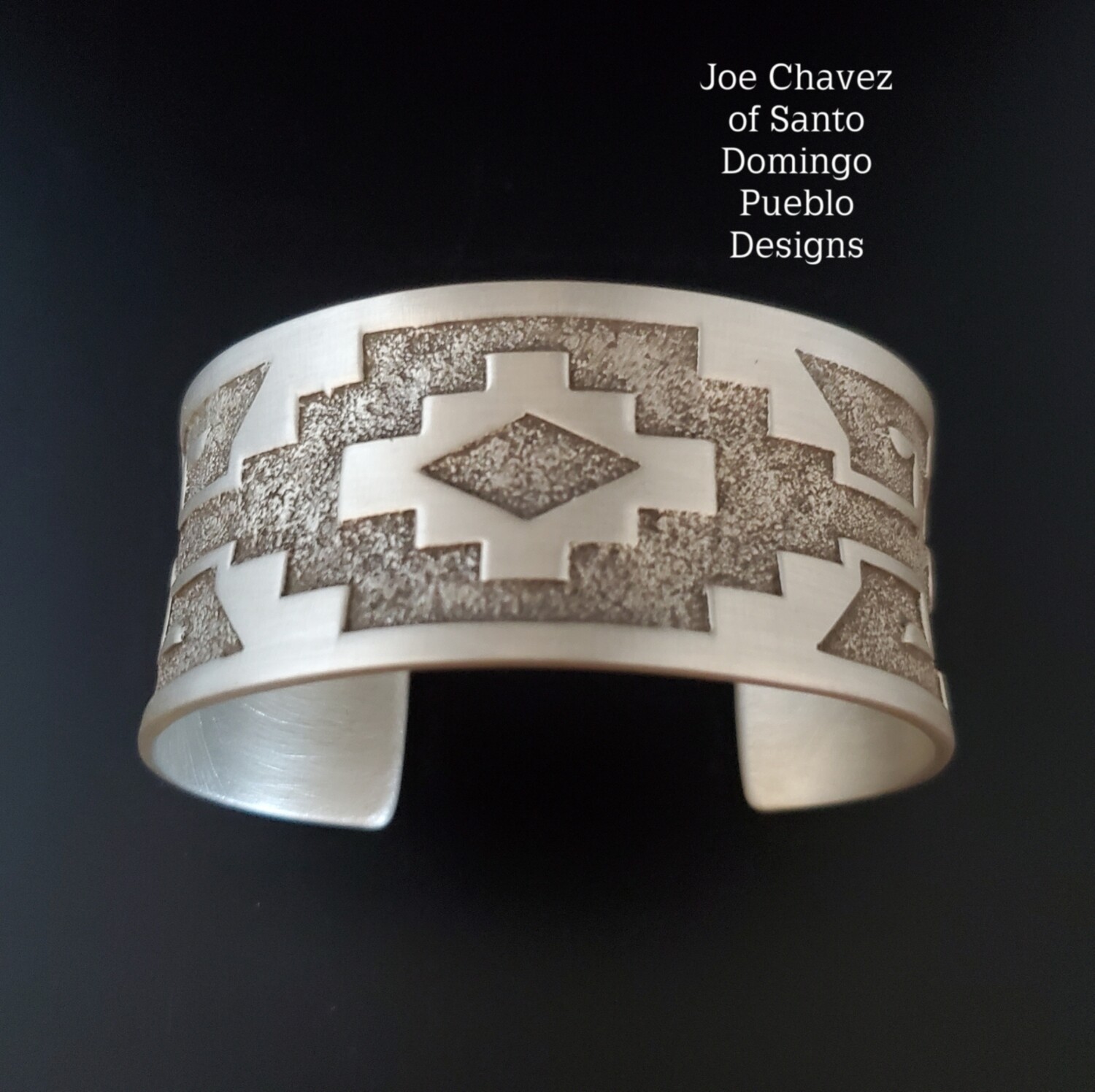Overlay sterling silver cuff with traditional Pueblo symbols