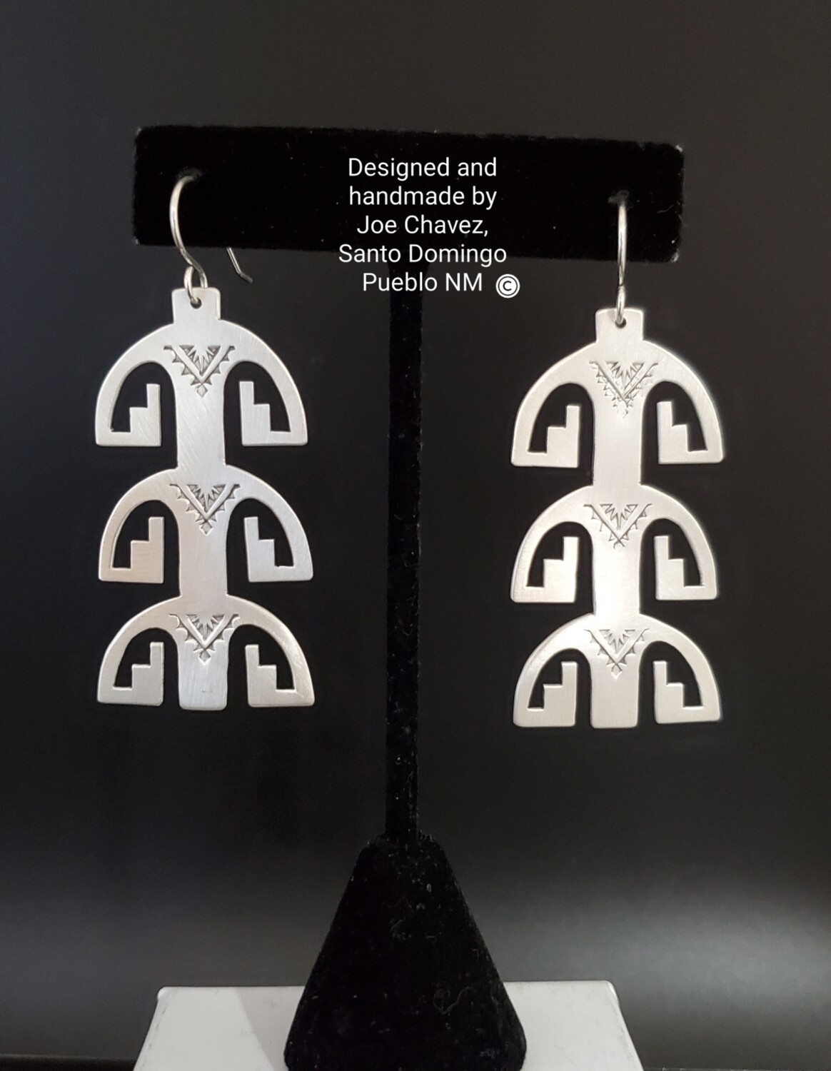 Sterling silver earrings with traditional Pueblo symbols
