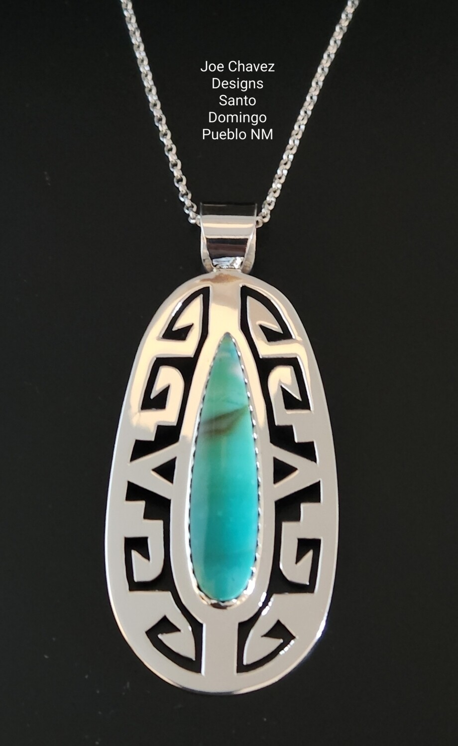Sterling silver pendant with Petrified Opalized Wood, traditional Pueblo symbols on the silver