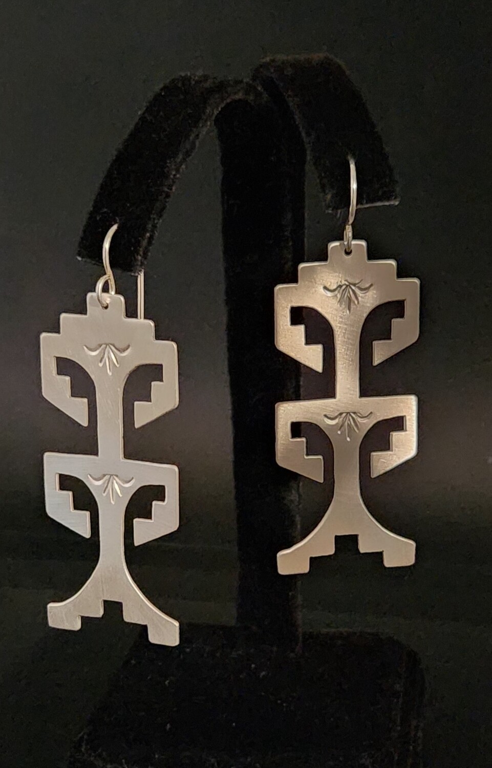 Sterling silver earrings with traditional Pueblo symbols