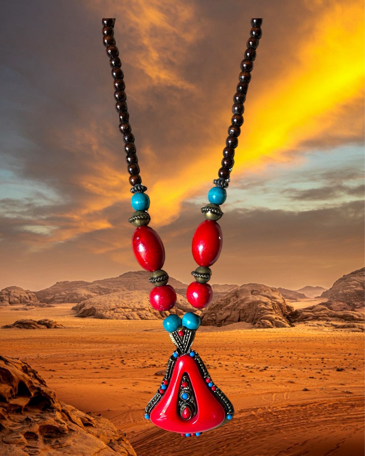 Large, statement boho beaded necklace featuring a striking pendant in vibrant red and blue resin on a brown wood base.