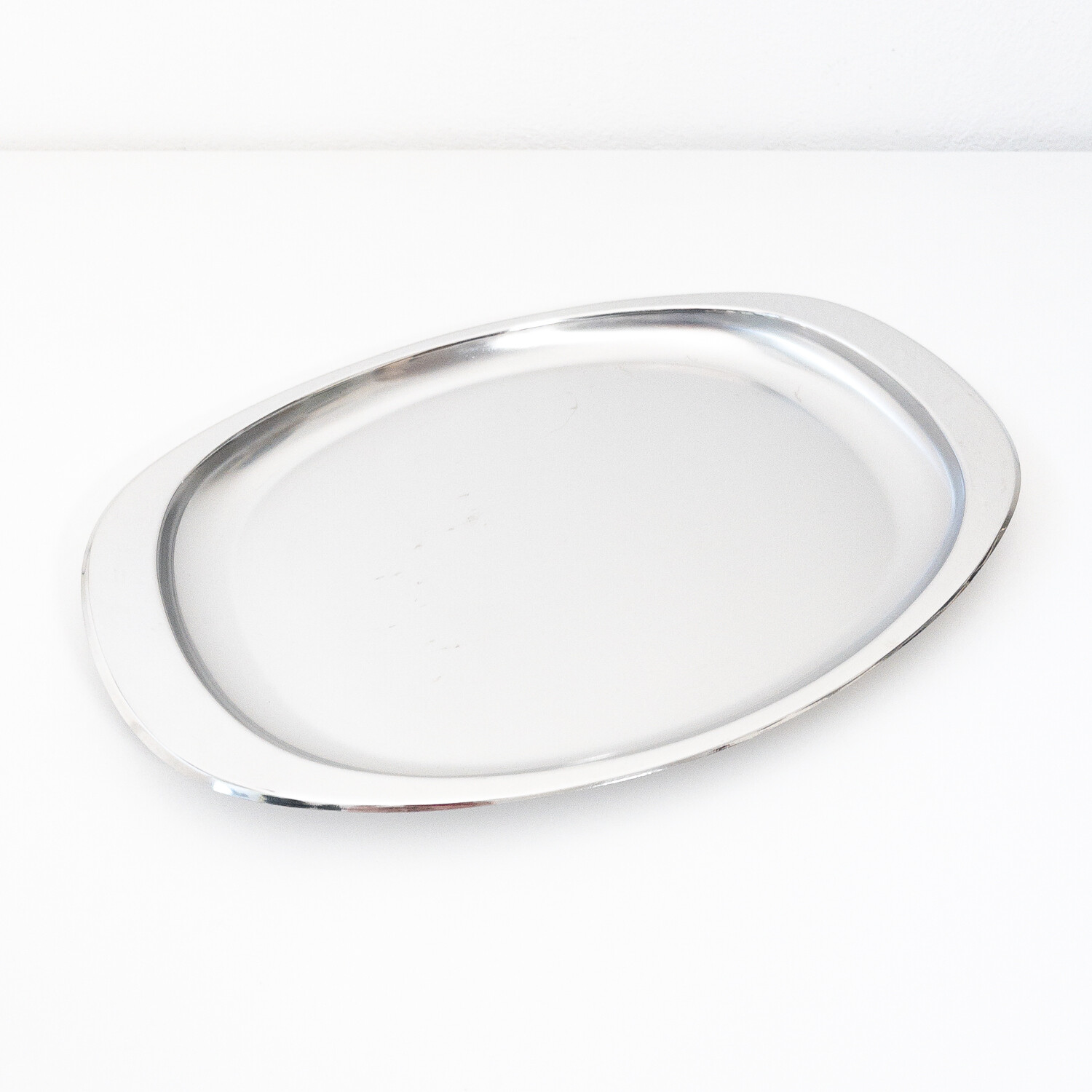Oval stainless steel serving plate model 115/35 by Alessi