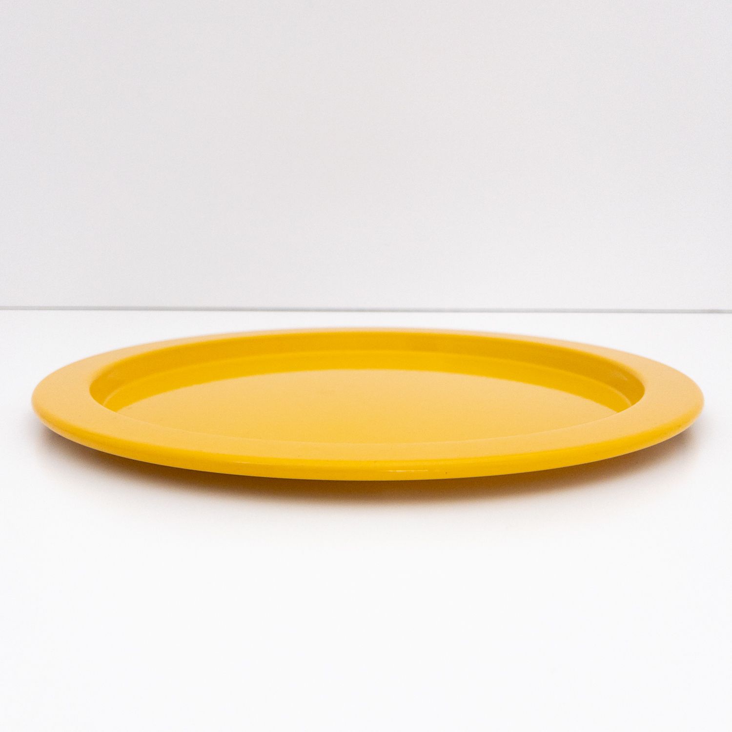 Alessi vintage tray underplate in saffron yellow painted metal, designed by Stefano Giovannoni, 1980s