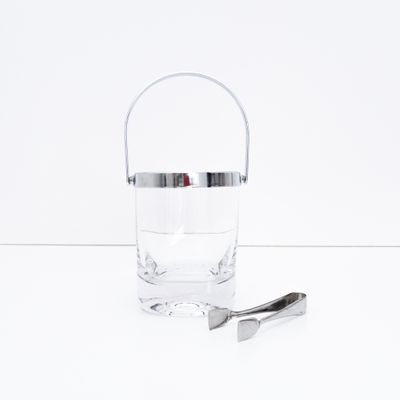 Ice bucket with glass body and chrome metal trim and tongs