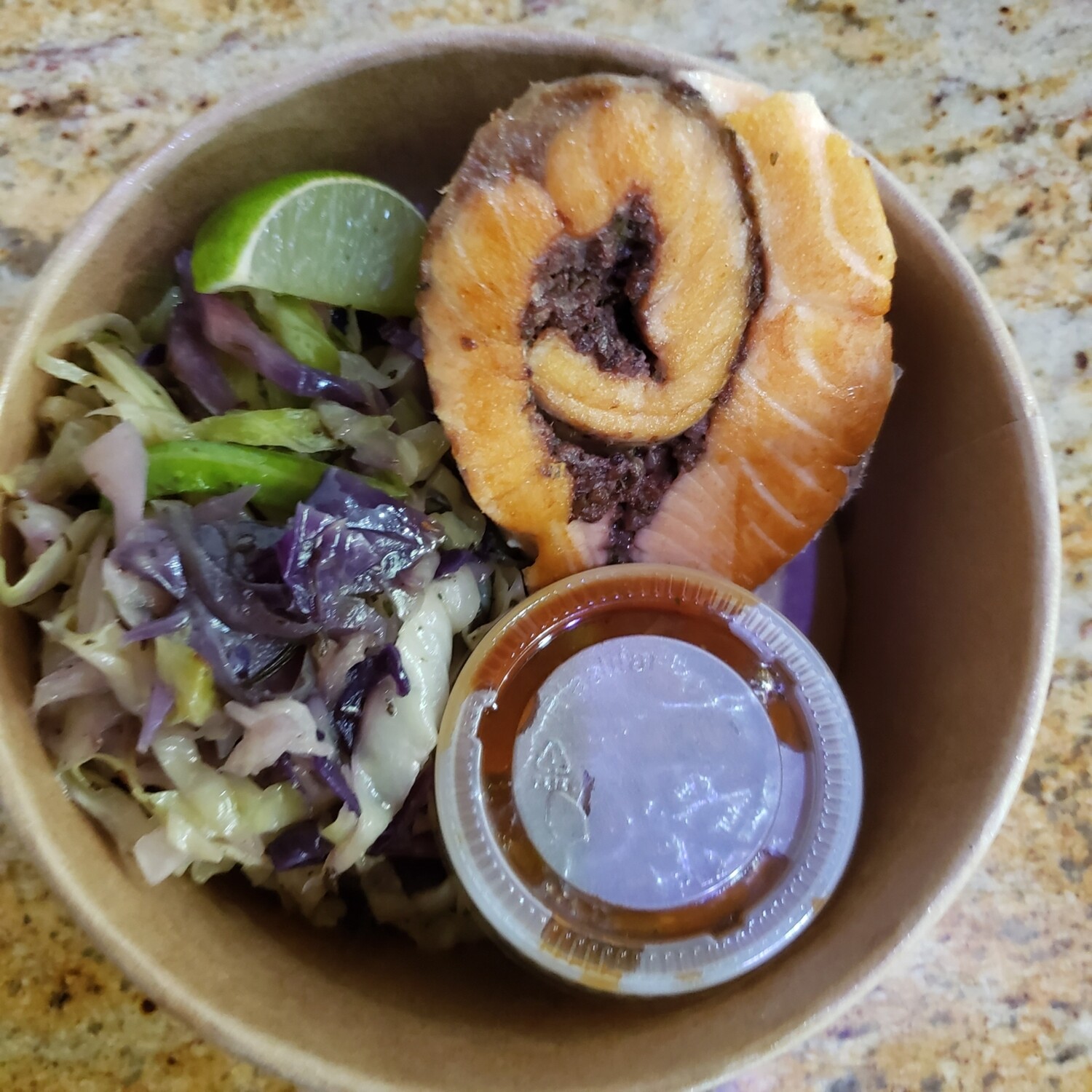 Tapenade stuffed rolled salmon, black olives,  capers, tomato sauce, butter and Mediteranean herbs cabbage fondue. Gf, k