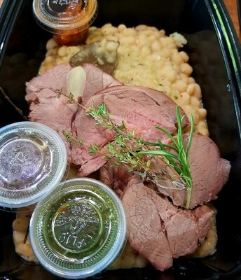 Mediteranean herbs Roasted Leg of Lamb, white beans cassoulet, side of almond pesto. Gf
