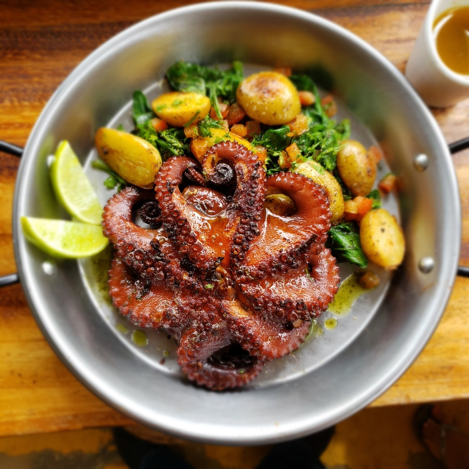 Grilled pesto and Mediterranean herbs octopus,  sweet peppers and red onions, sauteed mini potatoes and white wine spinaches. Gf, lf