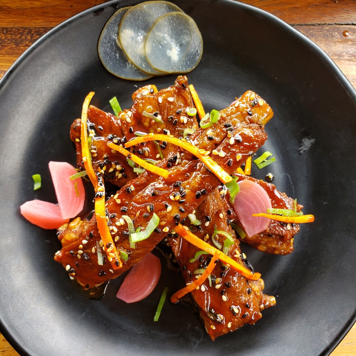 Poached and seared pork short ribs, teriaki sesame sauce, preserved cucumbers and radishes, carrots julienne, sticky rice and sauteed greens Gf, lf