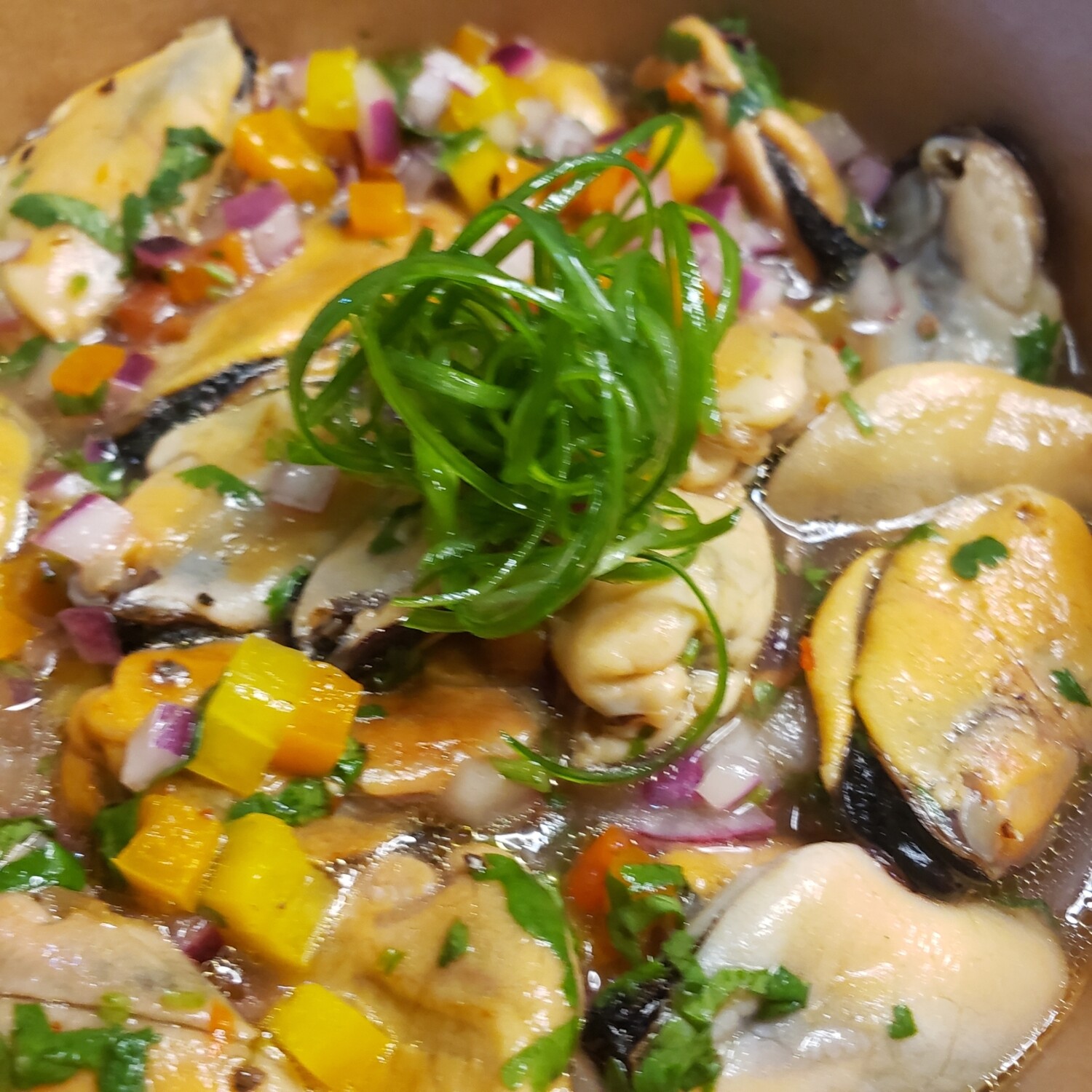 Mussels ceviche, side of sriracha and fried plantains chips.