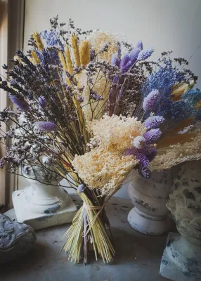 Dried flower bouquet in natural and lavender tones.