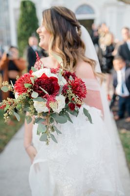 A bride holds a fresh flower wedding bouquet by Coventry Crossing Florist in Stone Harbor NJ