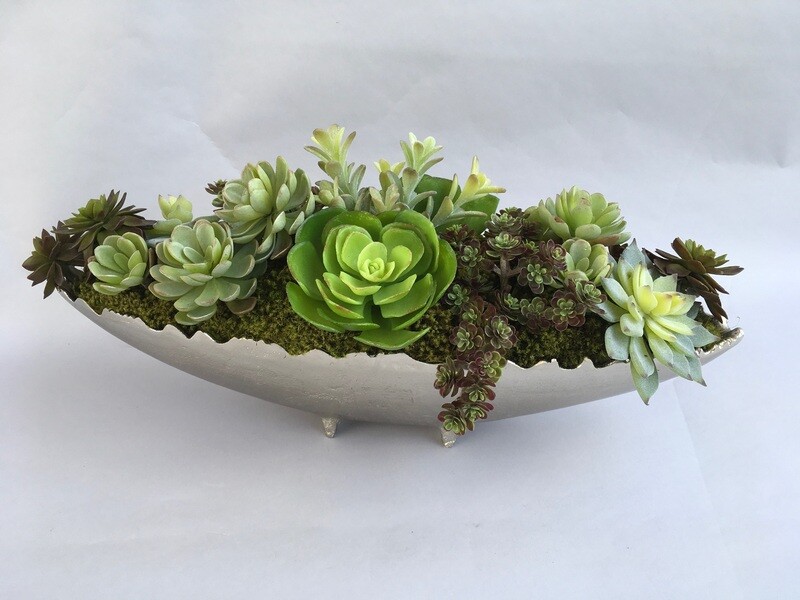 Donkey tail, sedum, agave and echeverias in an oval silver vase