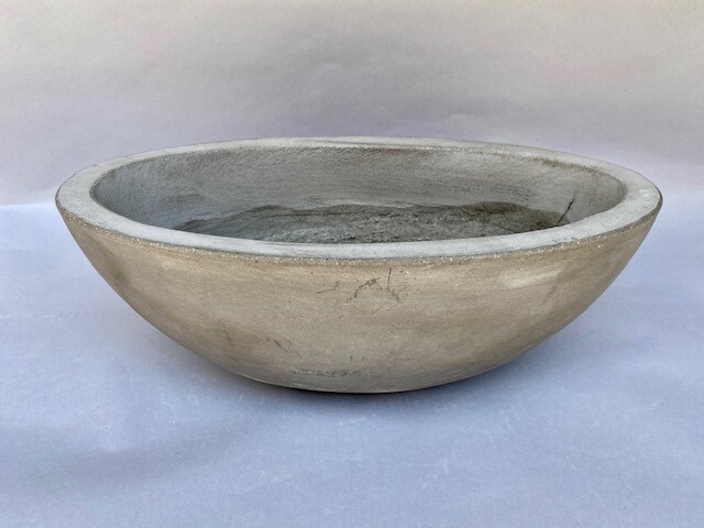 Weeping berries, kalanchoe, jade and echeveria succulents in an oval concrete bowl
